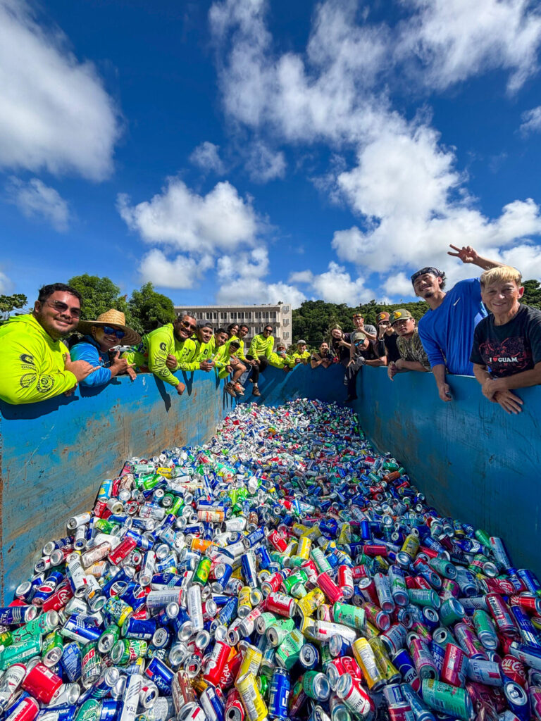 Members of the the fifth season of G3CC, the first season of GROW Corps, and iRecylce showcase the 4,500 aluminum cans collected from the 81st Liberation Day Parade.