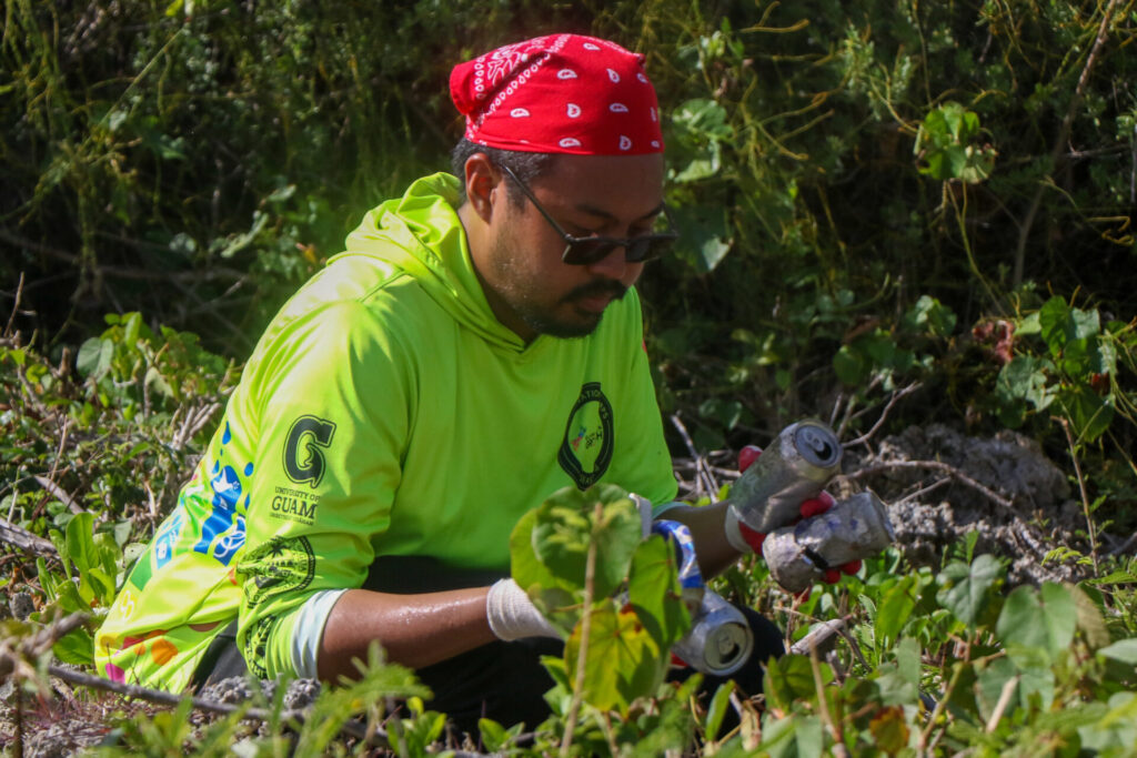 Rico Lizama of the Guam Green Growth Conservation Corps’ fourth season, sifts through recycleable aluminum cans during an island beautification event.  The Corps diverted over 13,000 cans from the landfill in 2024.