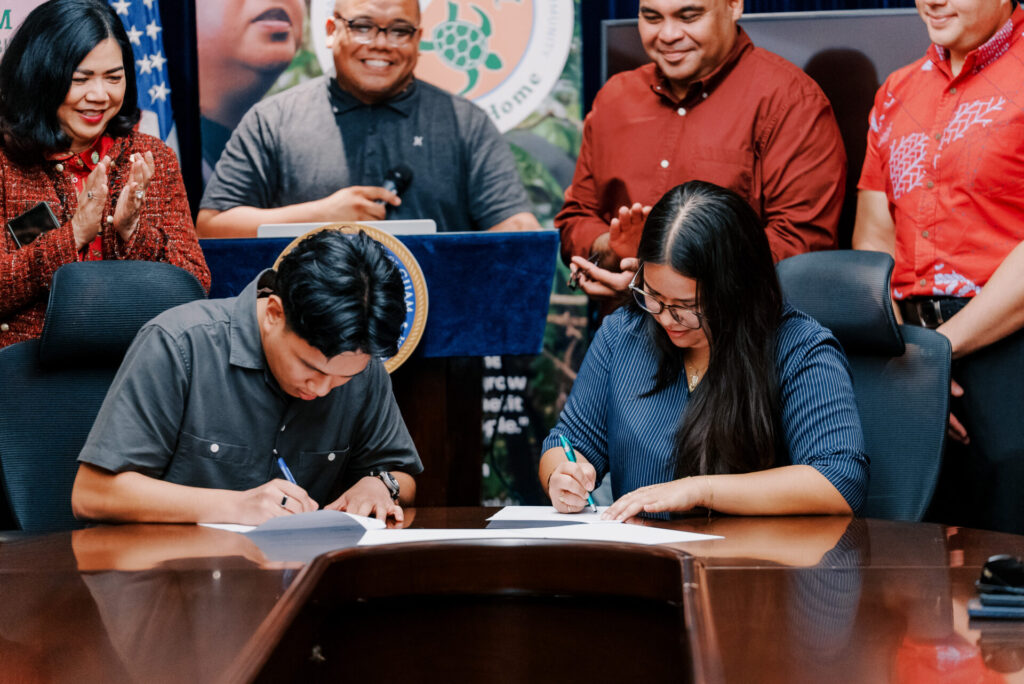 Miguel Cordero and Preya Camacho sign their official starting documents with the NSF Navigating Home program through the University of Guam Center for Island Sustainability and Sea Grant. The two new fellows are stationed with the Guam EPA and Department of Agriculture Biosecurity respectively.
