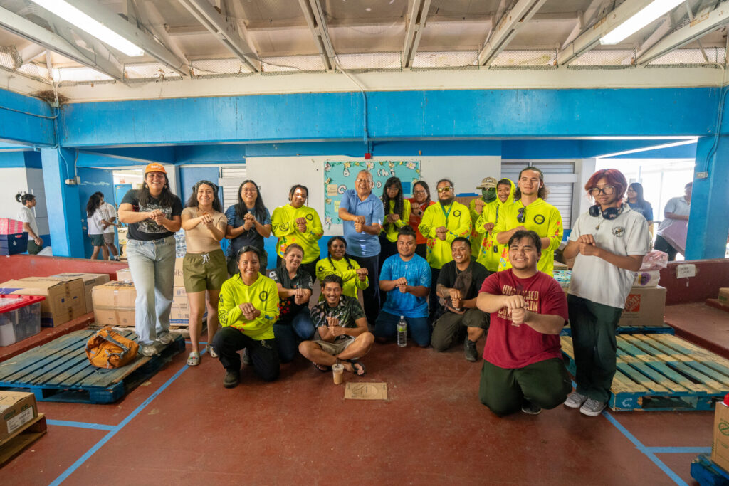 Guam Green Growth Conservation Corps members and volunteers pose with relief supplies at LBJ Elementary School during a Super Typhoon Sinlaku donation drive.