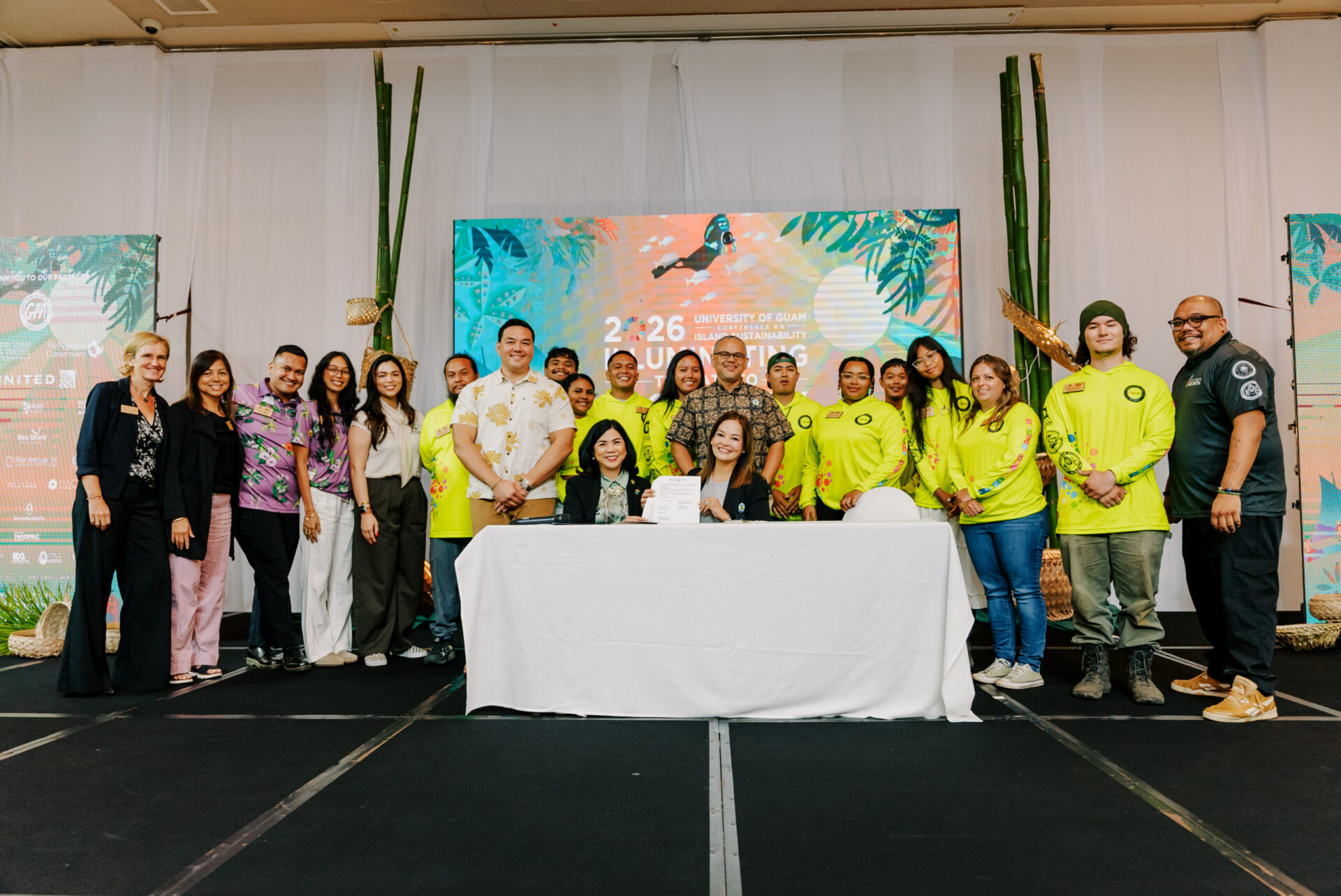 Leaders and representatives from Green Growth movements across Micronesia and Hawaiʻi pose with a signed document at the 17th UOG Conference on Island Sustainability.
