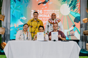 Gov. Lou Leon Guerrero, Lt. Gov. Josh Tenorio, and Francois Rogers hold signed documents at the 17th UOG Conference on Island Sustainability.