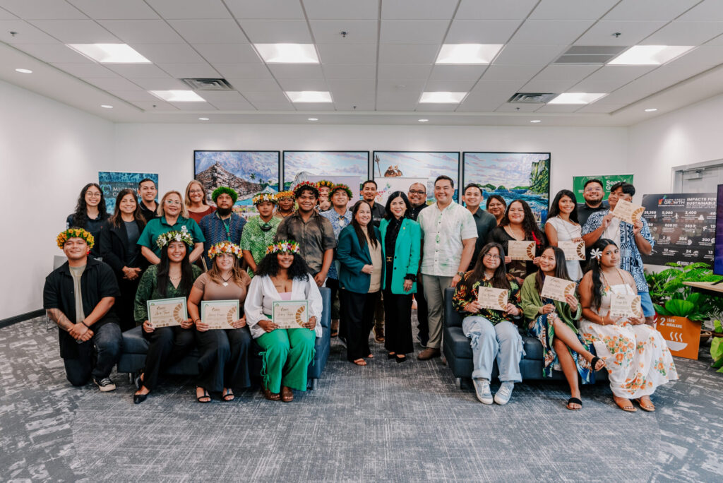 A group graduation photo of the G3 Conservation Corps and Youth Conservation Corps, posing indoors with certificates, flower crowns, and UOG leaders.