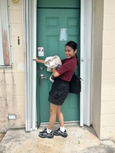 Riyo Anne Reyes tries her hand at closing a typhoon shutter at House 21,