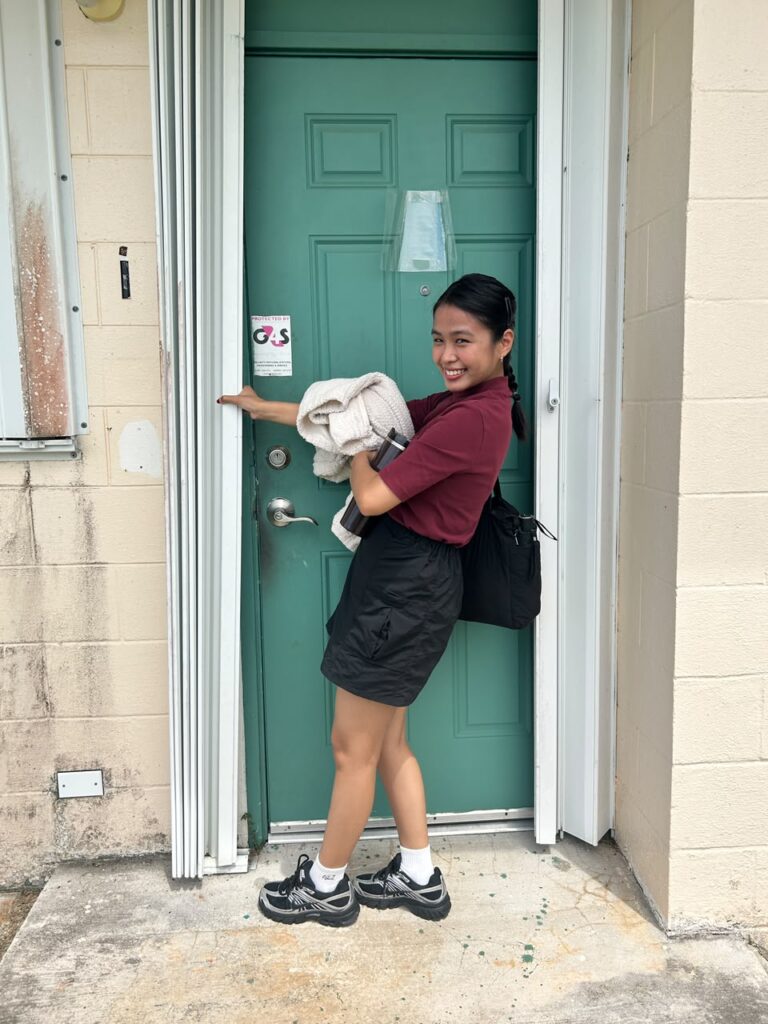 Riyo Anne Reyes tries her hand at closing a typhoon shutter at House 21,